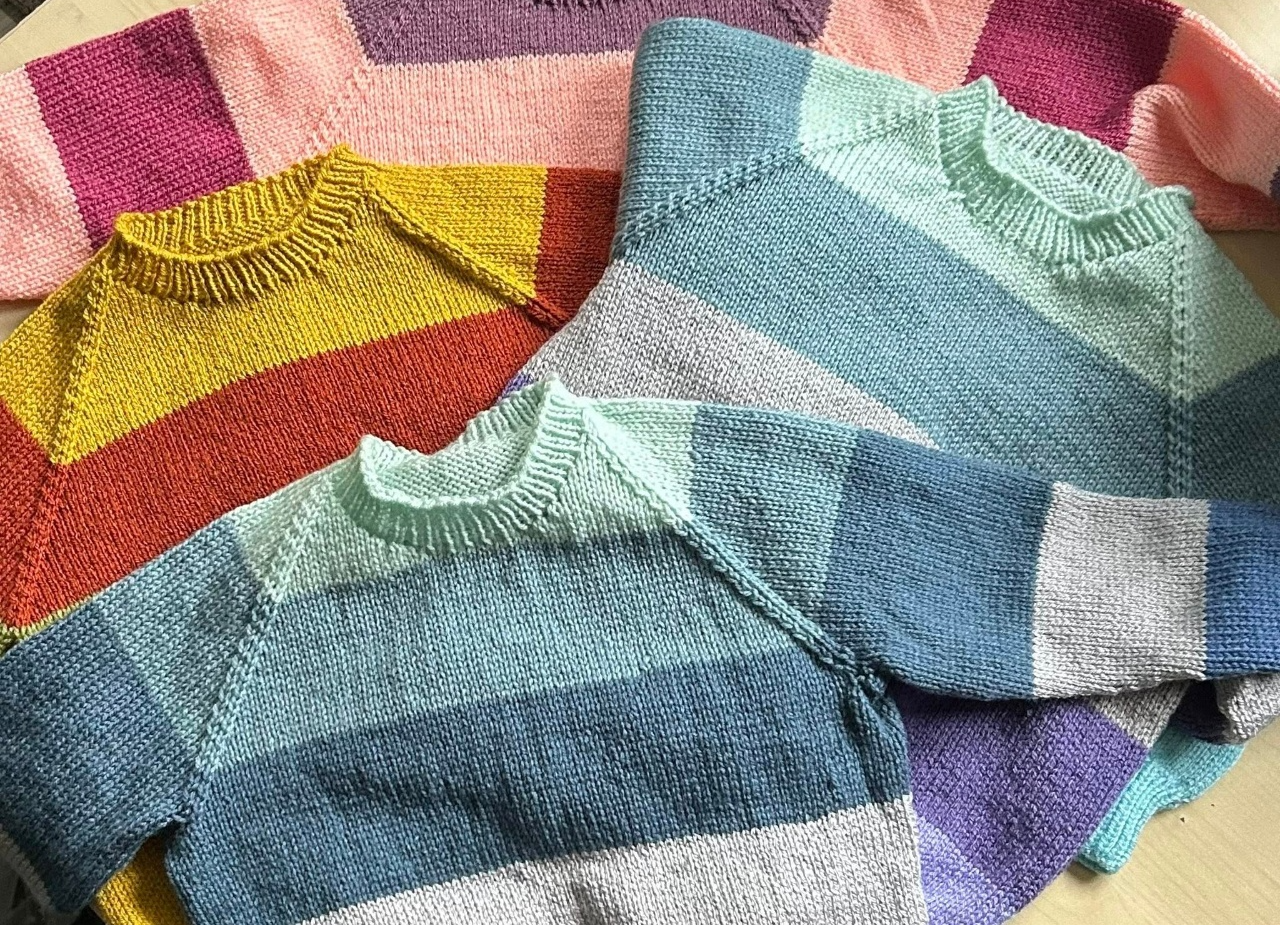 Colourful knitted jumpers for children created in the Swindon Big Knit