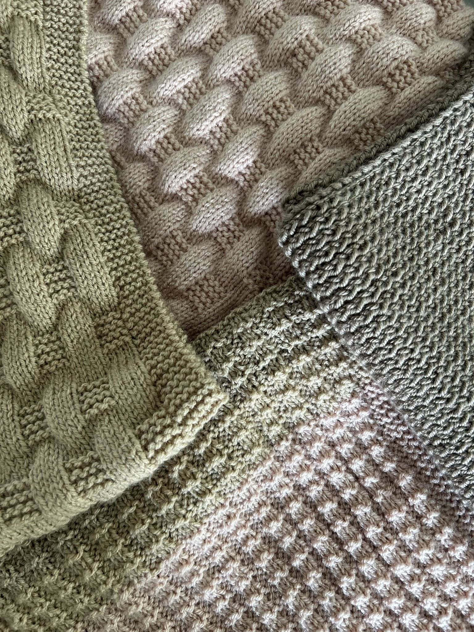 Close‑up of hand‑knitted panels in natural beige and green tones, showing cable, basketweave and textured stitch patterns.